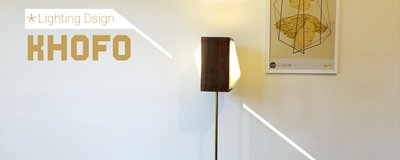 This architectural image showcases a modern floor lamp with a geometric wooden shade and brass stand