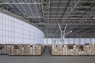 This architectural image showcases the interior of a modern warehouse. The space is characterized by