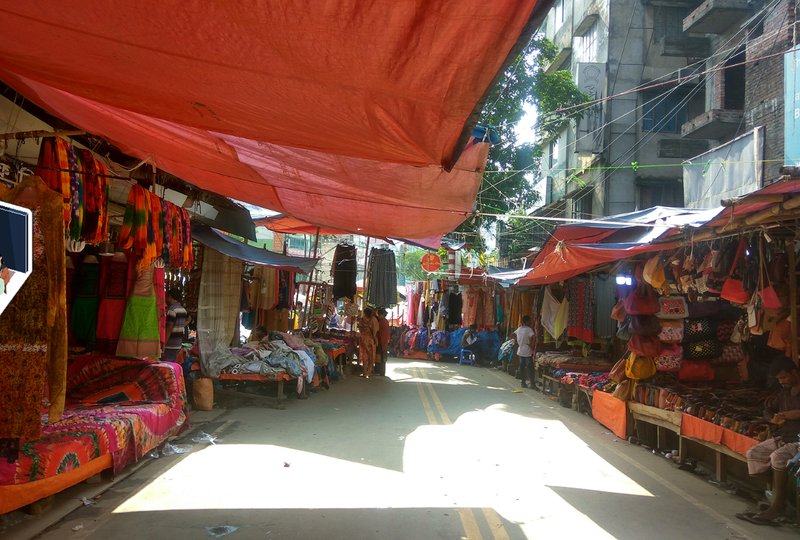 Local market stalls in Dhaka, offering vibrant textiles and goods.