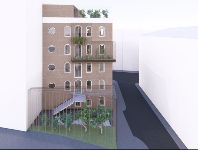The rear facade of Co-Biophilic, integrating greenery and modern glass structures while honoring its historical roots.
