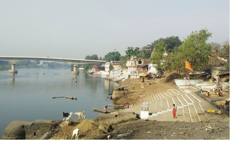 A serene confluence of daily life and devotion, where the sacred Narmada meets the vibrant spirit of the community.