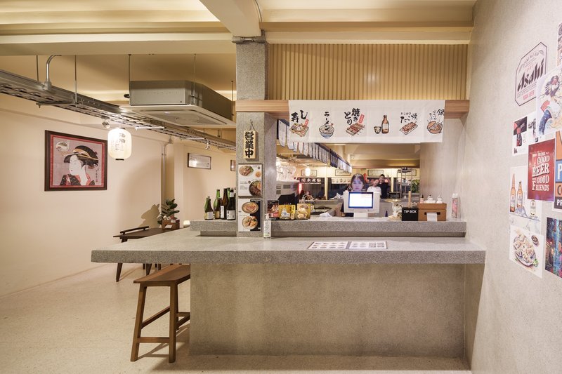 JIM's Recipe bar corner: concrete counter, timber stool, Japanese-style wall graphics, slatted ceiling