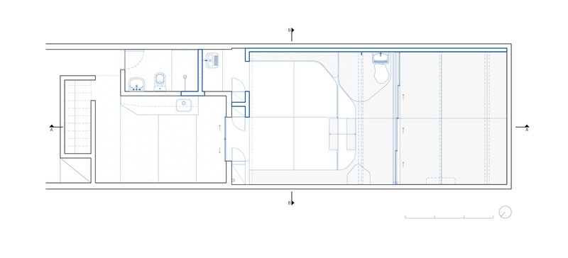 Transverse section through atelier: sliding glass facade, concrete steps, planted courtyard, figures for scale