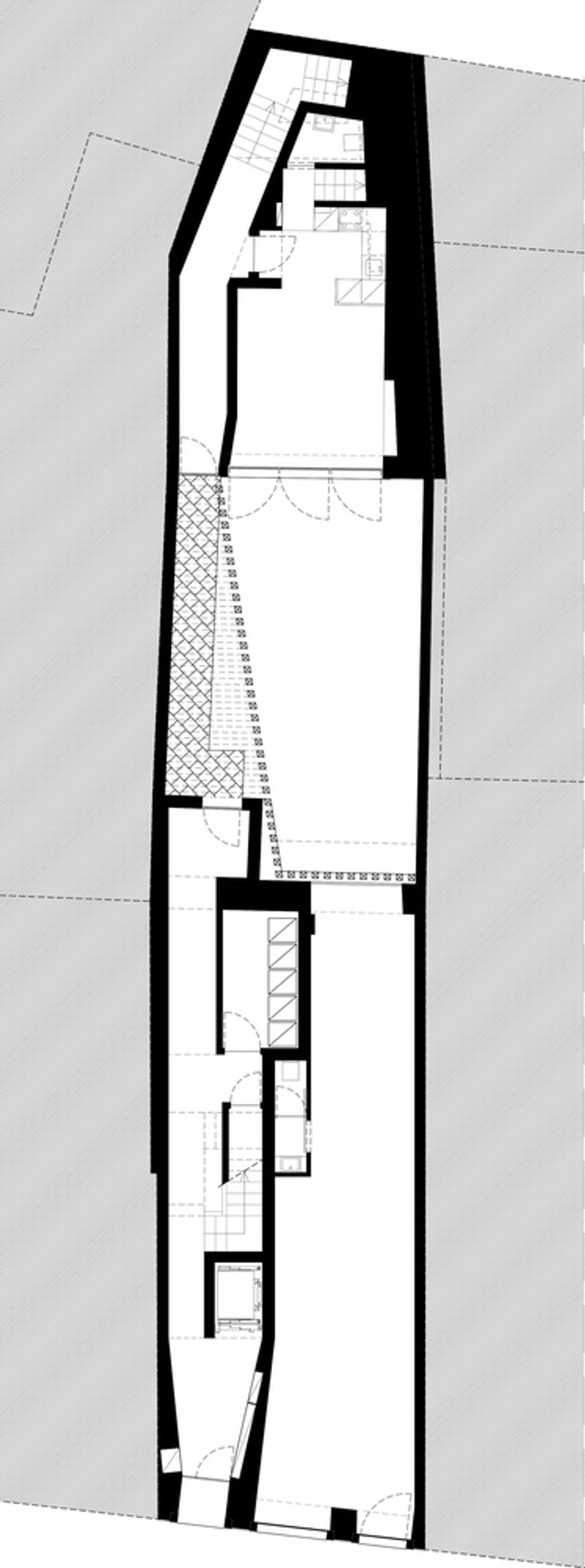 Floor plan drawing showing narrow building footprint with diagonal courtyard and stair