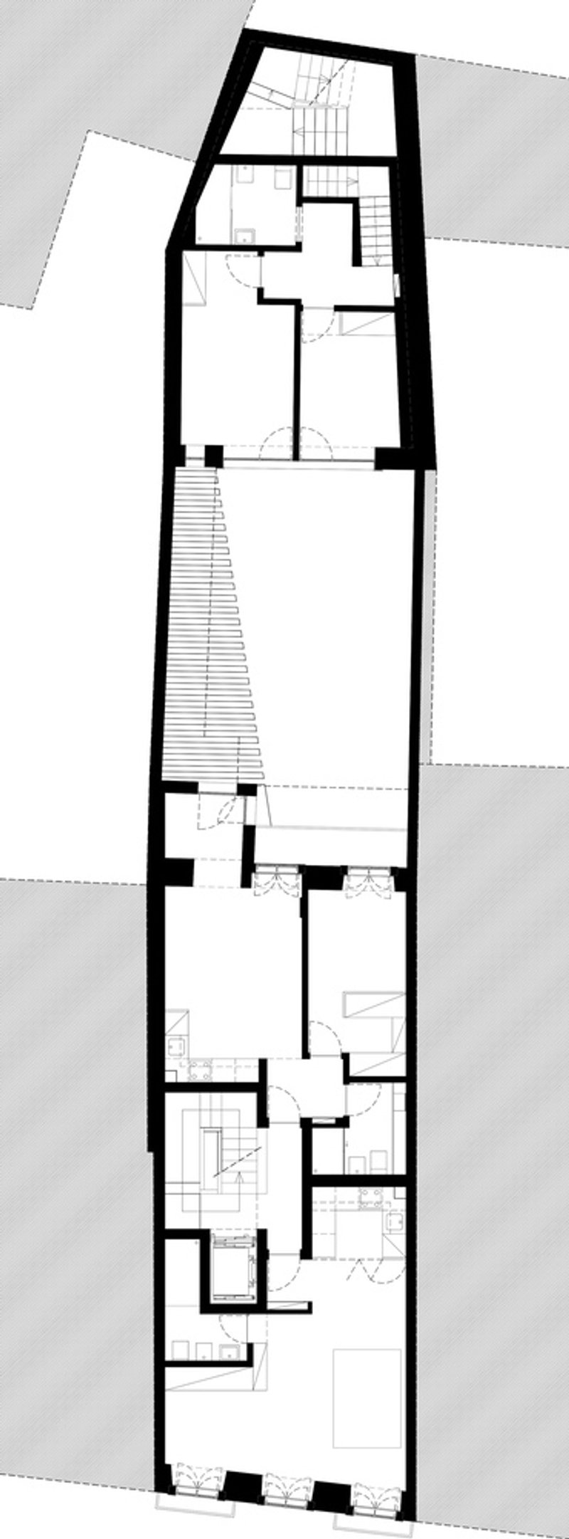 Floor plan drawing showing rooms arranged along a diagonal courtyard with hatched paving