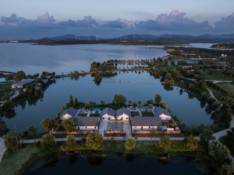 Drone view of the symmetrical compound on a peninsular island surrounded by water