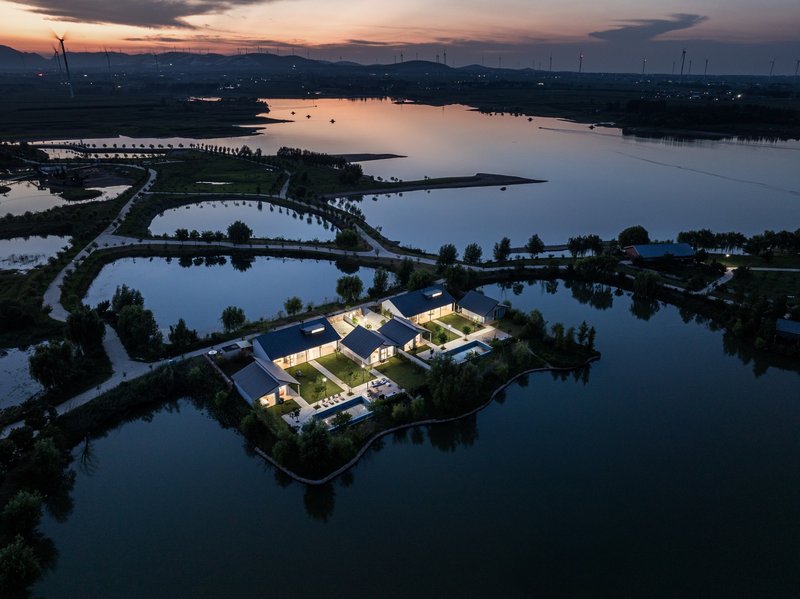 Aerial view of the residential complex on its island at sunset with surrounding waterways
