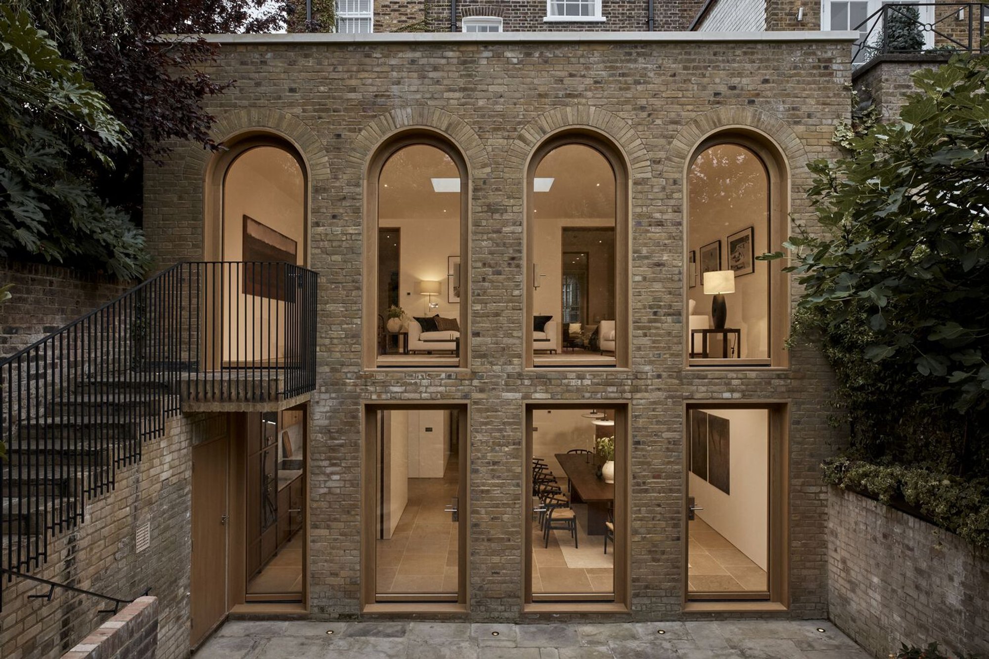 Joseph Mills Architects Restores a London Townhouse with Arched Openings and a Brick Courtyard