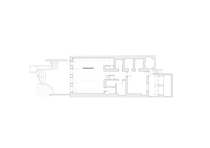 Floor plan drawing showing a narrow linear apartment with curved staircase at left end