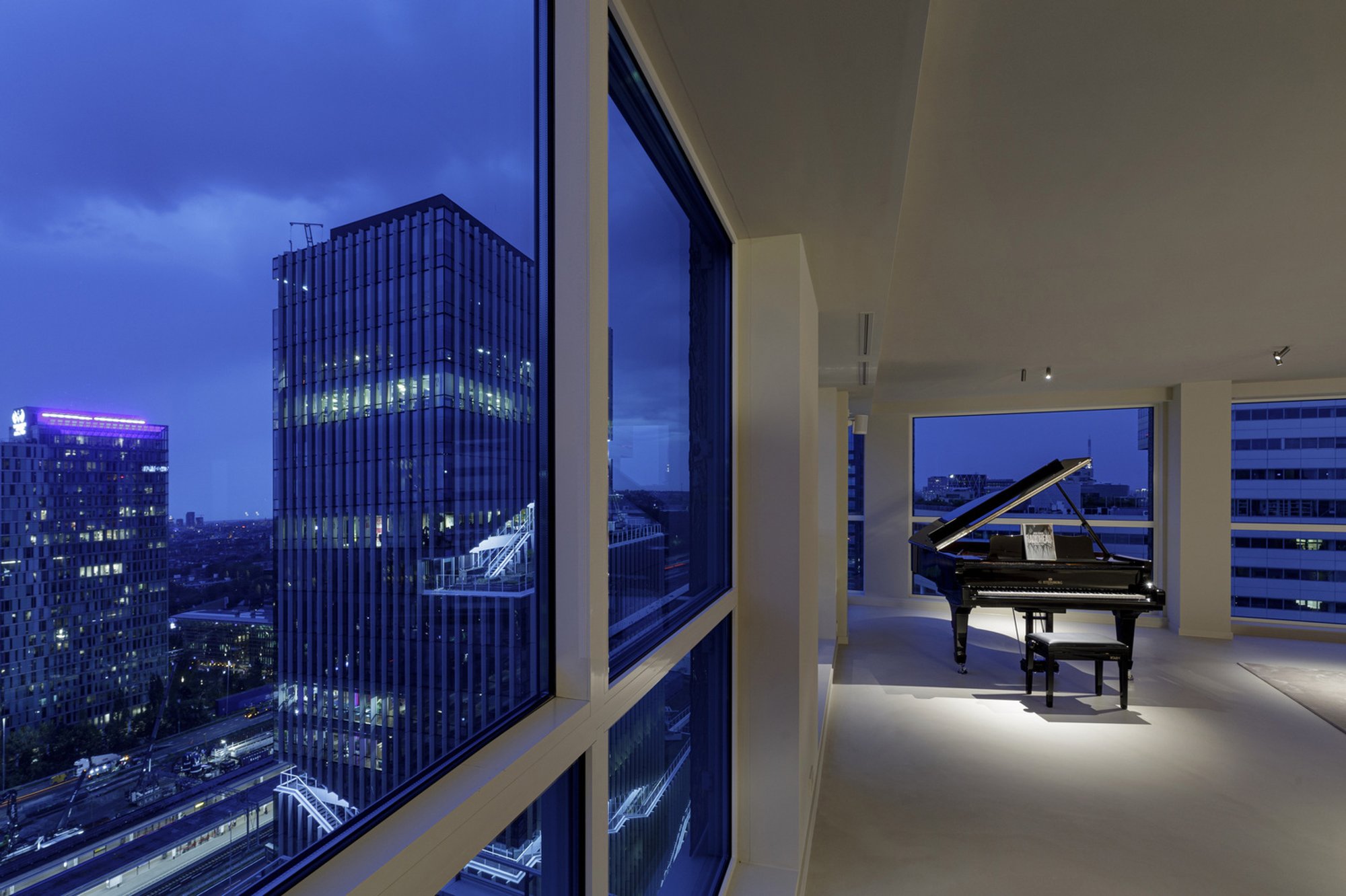 i29 Turns a High-Rise Apartment into a Warm Sequence of Timber-Lined Rooms with a Panoramic View