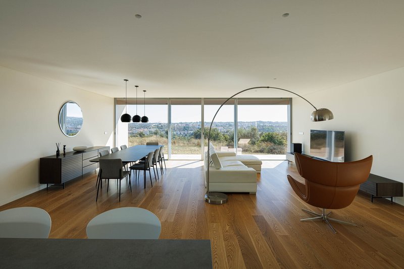 Living area with sliding glass doors opening to a terrace with hills visible in the distance