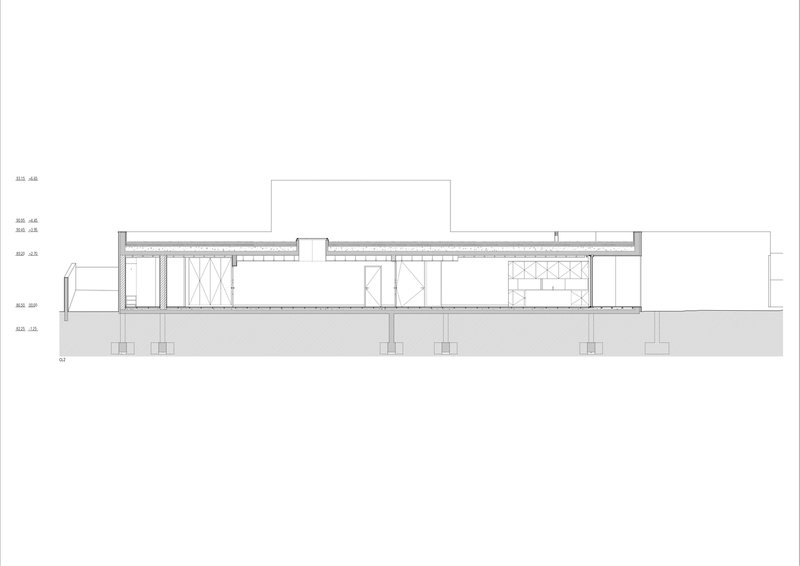 Section drawing showing linear volumes with varying ceiling heights elevated on columns above sloped ground