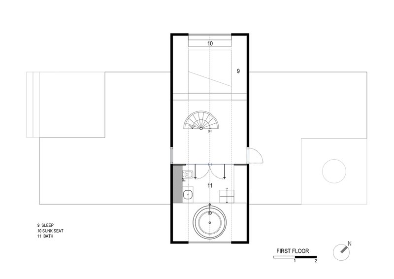 First floor plan drawing showing a narrow volume with spiral stair, bathroom, and circular tub