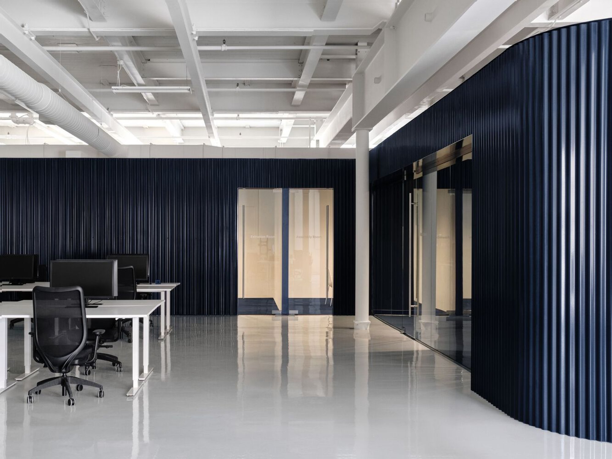 Ivy Studio Wraps a Montreal Tech Office in Dark Blue Corrugated Steel