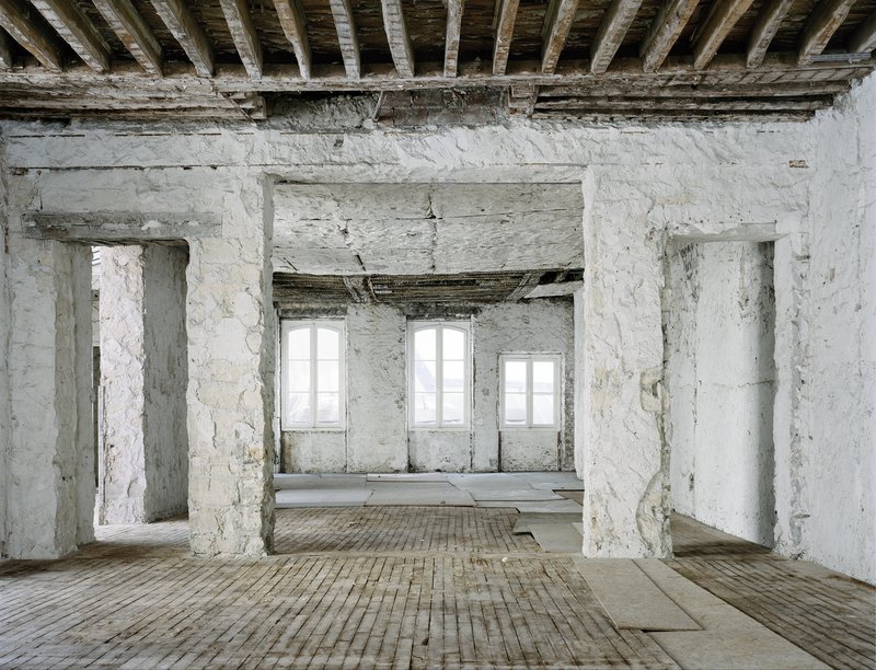 Before: thick masonry walls, timber joists above, three windows, exposed rubble