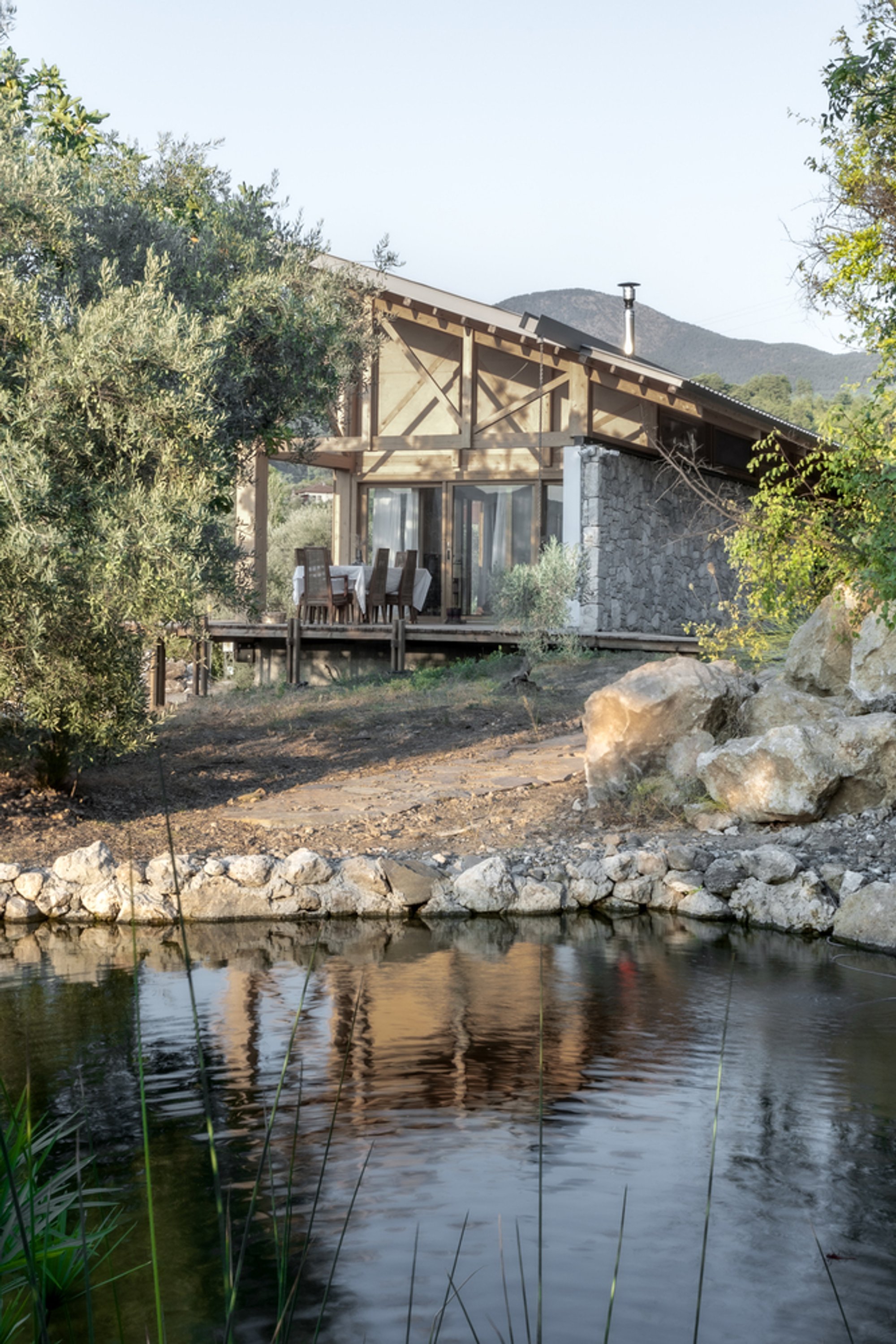 SO? Architecture and Ideas Splits a Turkish Hillside House Between Stone and Timber