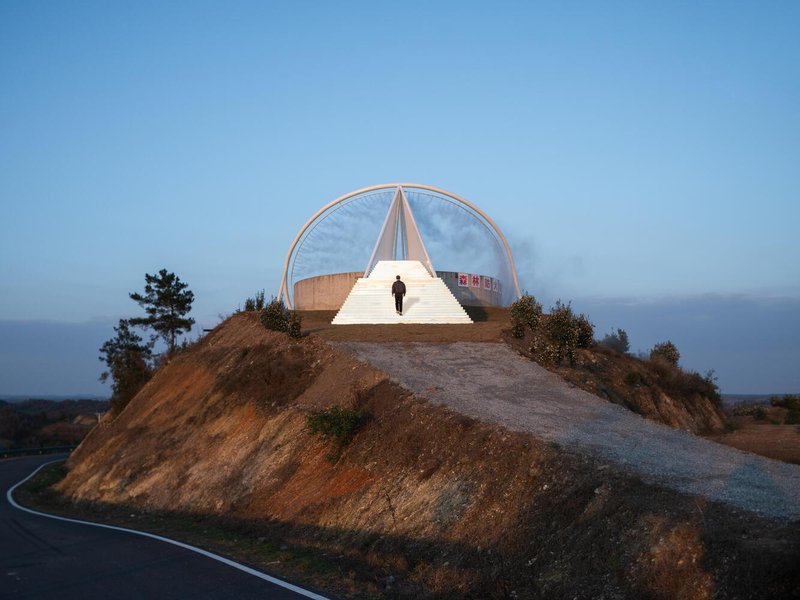 Reservoir approach at dusk: the triangular staircase leading up to the circular basin, arch framing the sky