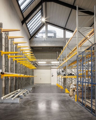 This architectural image showcases the interior of a warehouse or storage facility. The space featur
