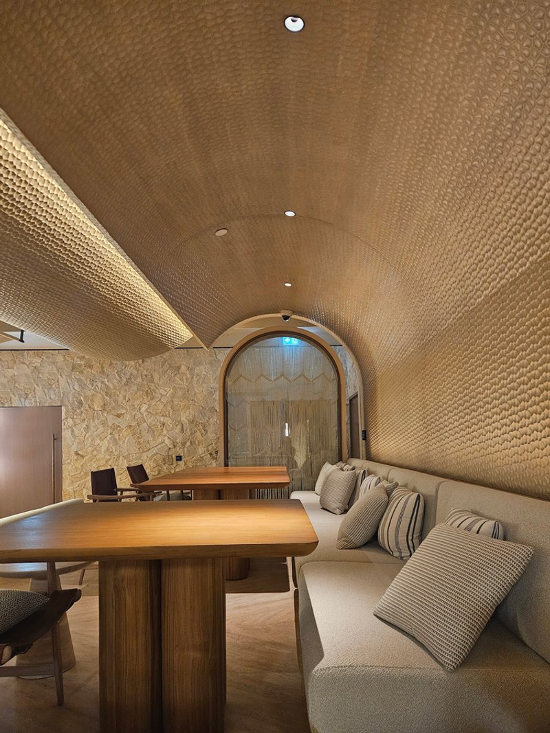 Nalu booth: arched woven ceiling close-up, bench seating, warm pendant light