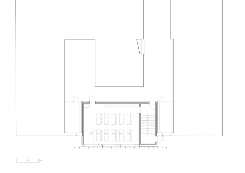 First-floor plan: the extension detail showing two classrooms with desks, changing room, and stair