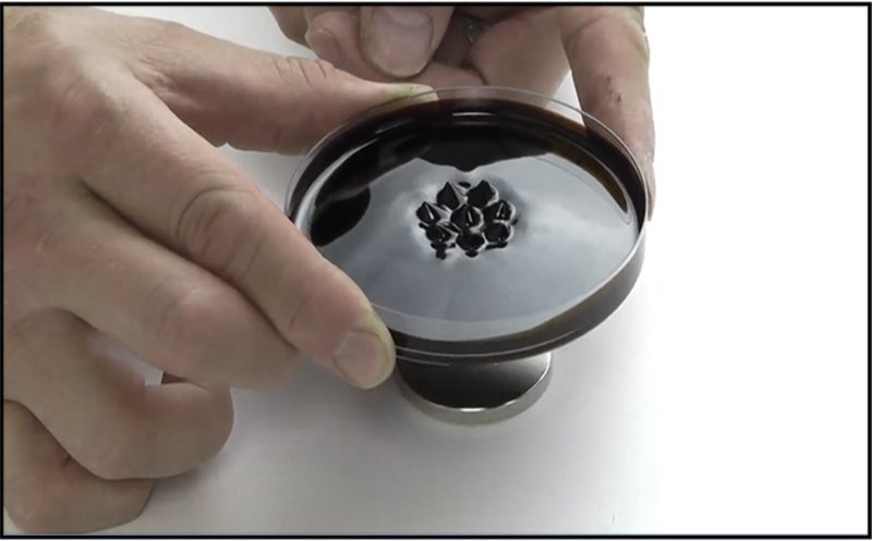 Hands-on manipulation of ferrofluid showcasing its versatility in design.