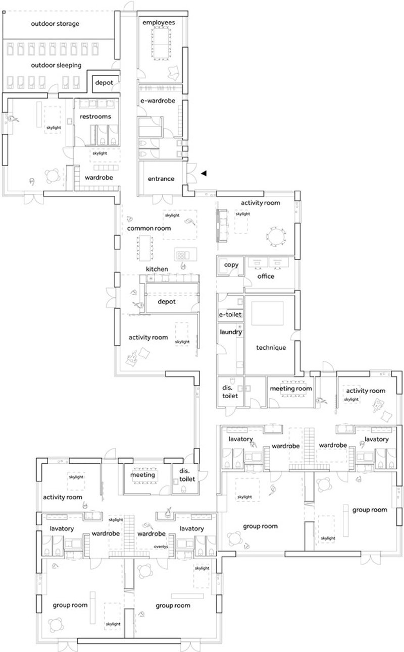 Floor plan drawing showing group rooms, activity spaces, and support areas arranged around central circulation