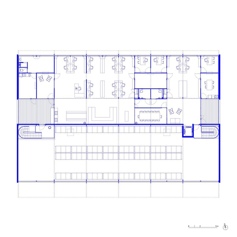 Upper level floor plan drawing with workstations, meeting rooms, and curved staircases at both ends
