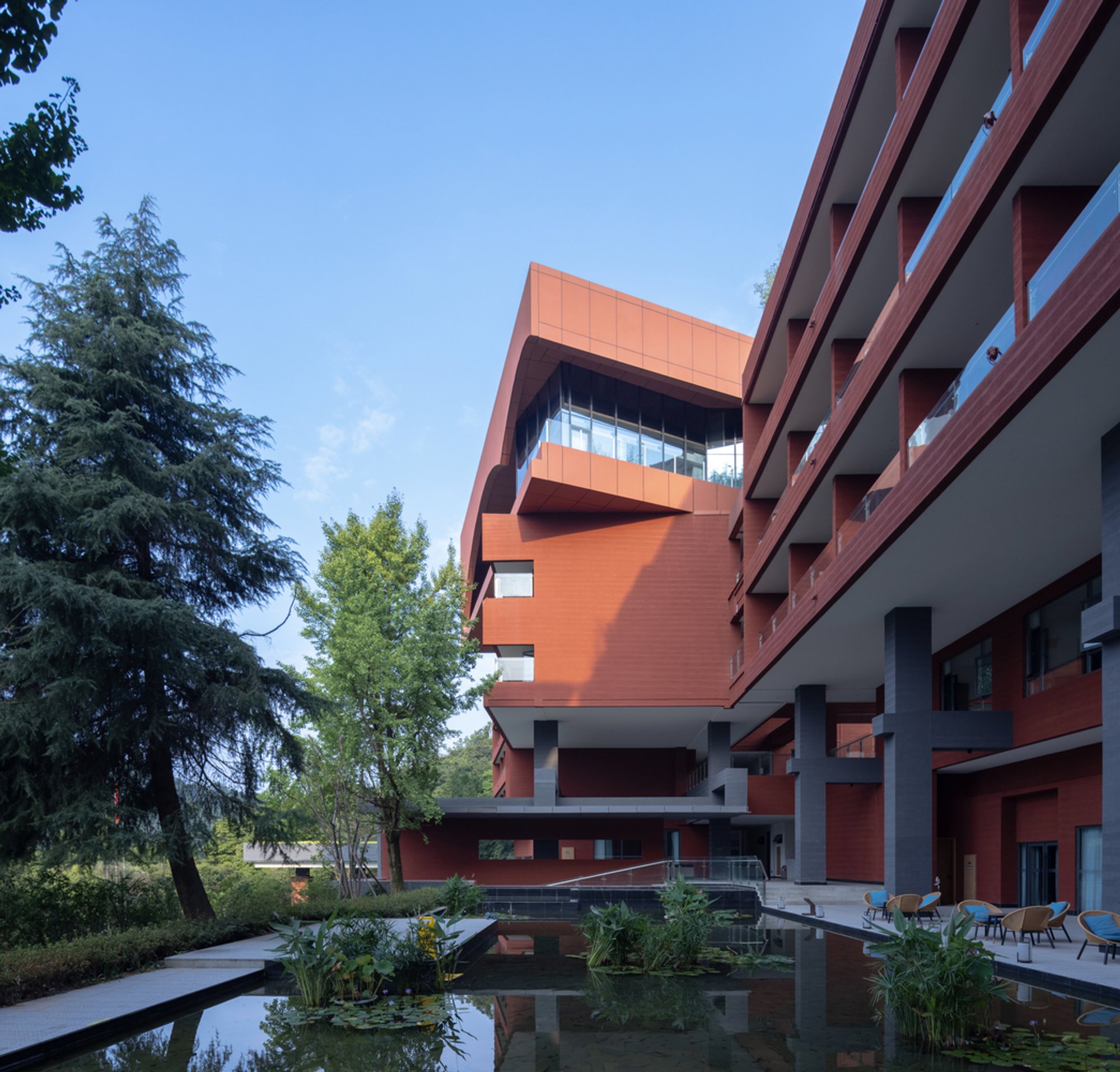 epos architecture Wraps a Sichuan Mountainside in Red Sandstone Volumes at Danling Lao'e Resort