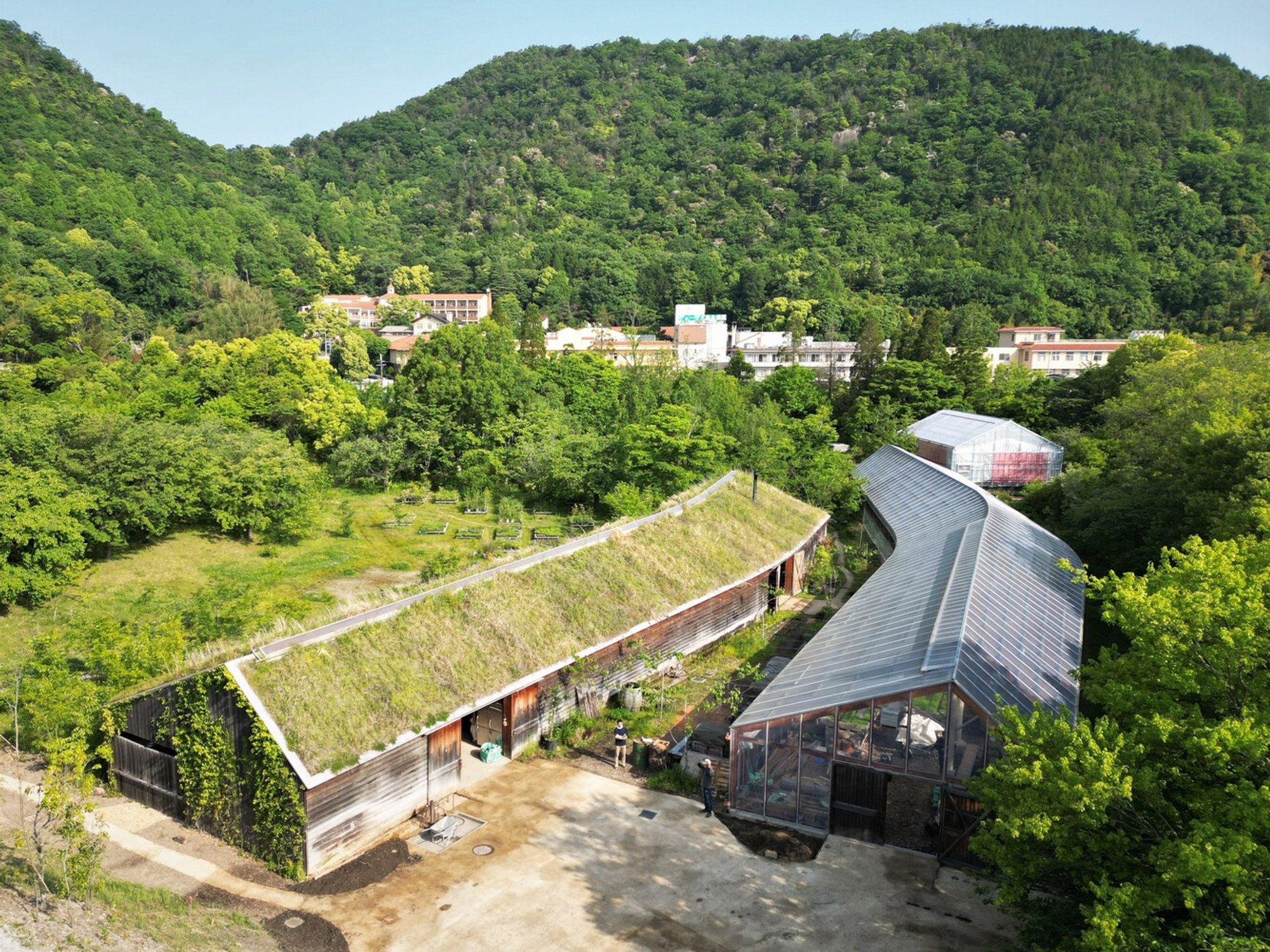 Kyoto University's Global Environmental Lab Plants a Greenhouse That Disappears into a Japanese Valley