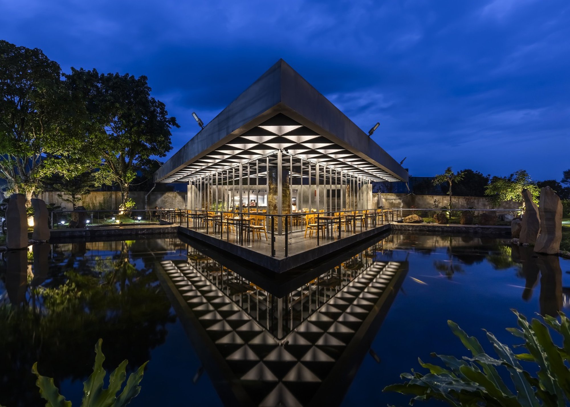 SPNG Architects and NTA-Architecture Float a Triangular Coffee Pavilion Over Koi Ponds in Vietnam
