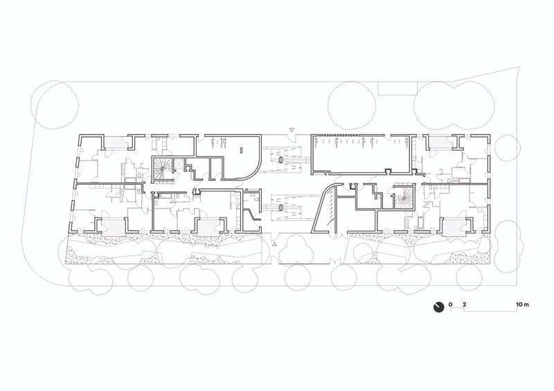 Floor plan drawing depicting residential units with outdoor terraces and landscaped perimeter with trees