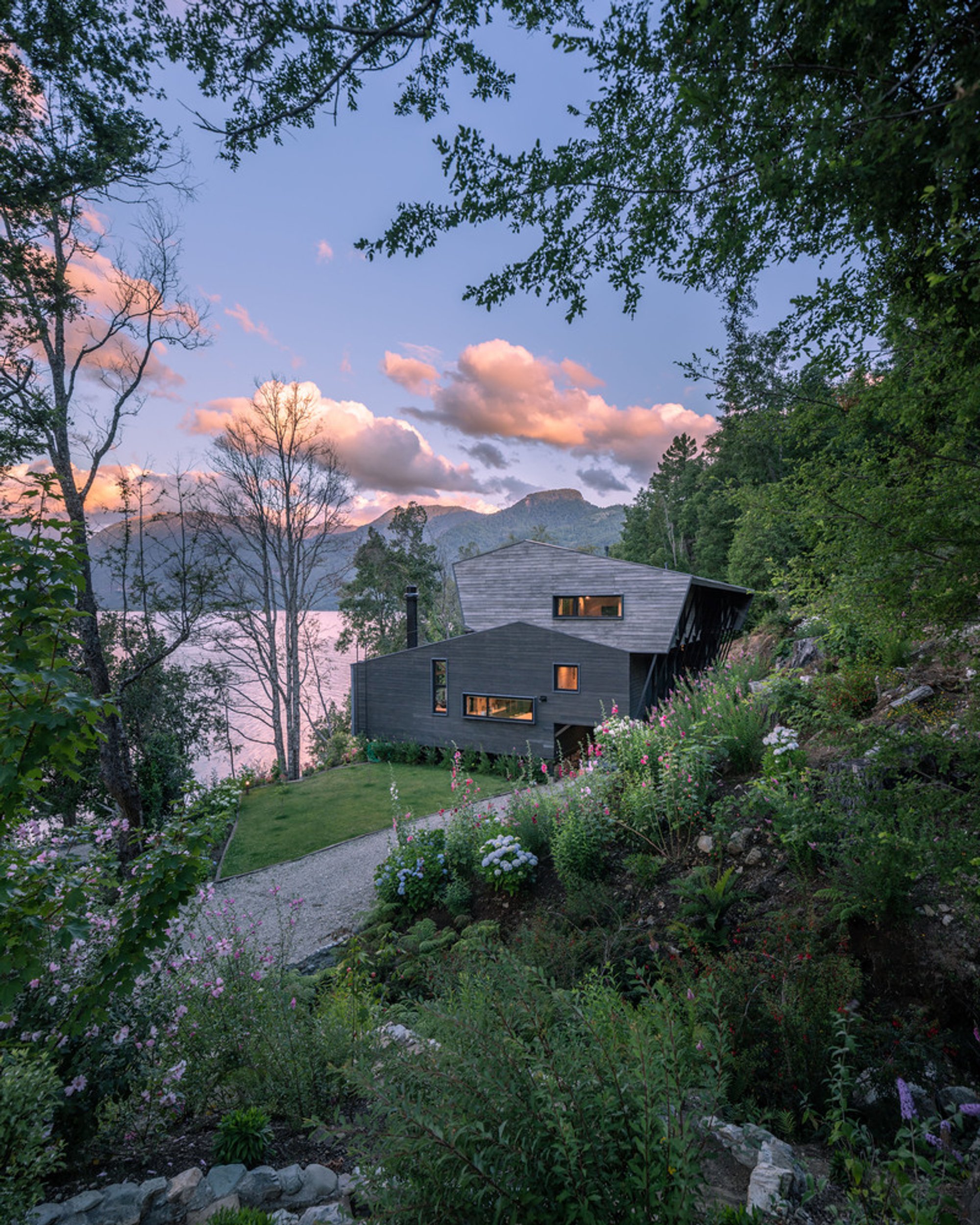 Schwember García-Huidobro Arquitectos Nests a Dark Timber House into a Chilean Lakefront Slope