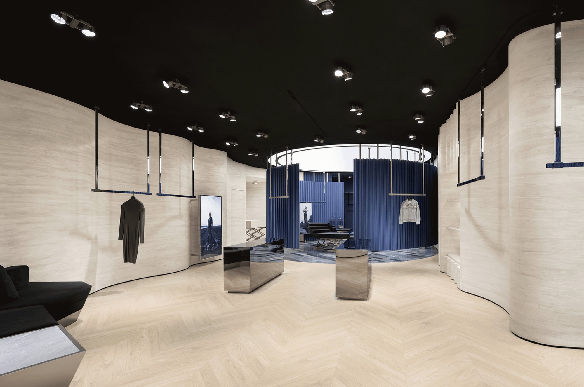 SLT Design Wraps a Hong Kong Boutique in Theatrical Blue Curtains and Rotating Stages