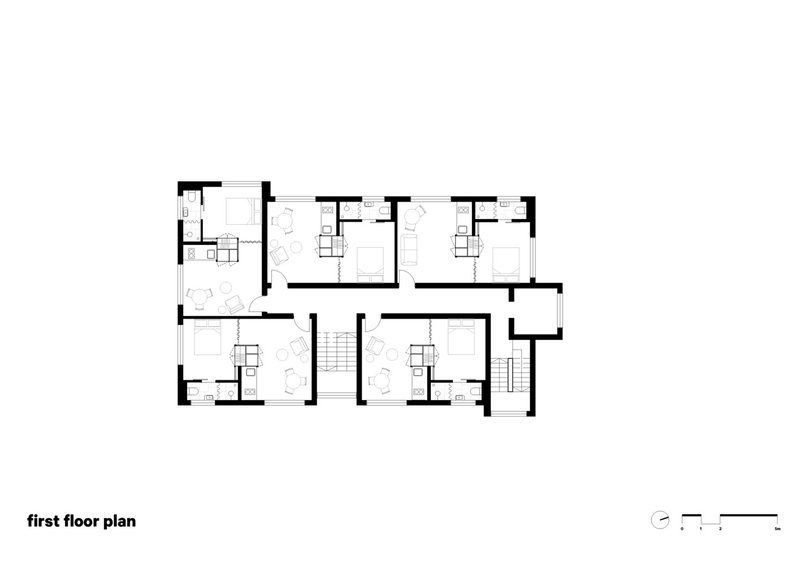 First floor plan drawing showing residential units arranged around two central stair cores