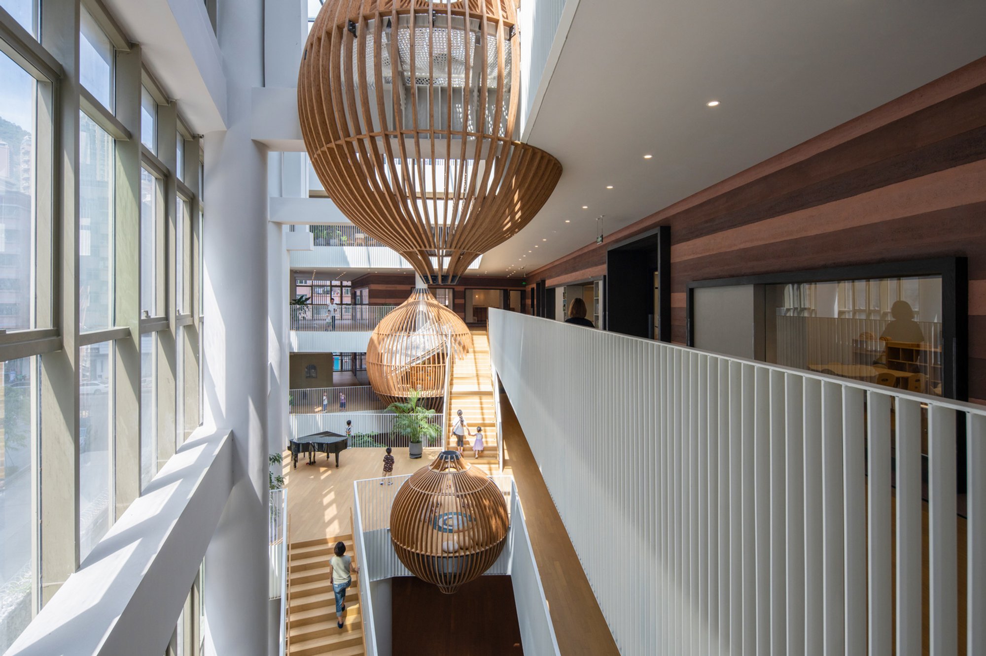 HIBINOSEKKEI and Youji no Shiro Nest a Four-Story Climbing Atrium Inside a Shenzhen Kindergarten