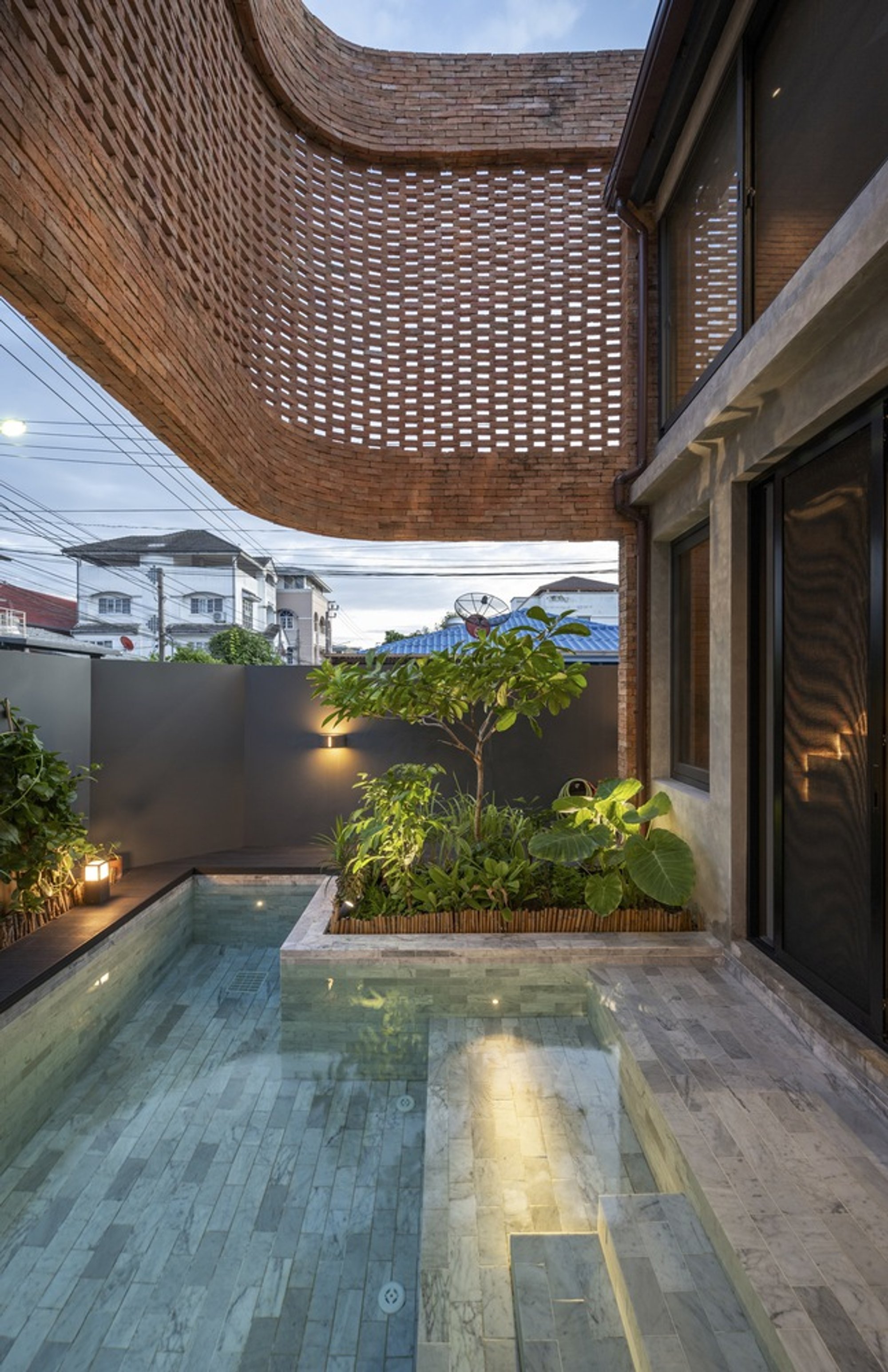 BodinChapa Architects Wraps a Bangkok Corner Plot in a Perforated Brick Shell That Breathes