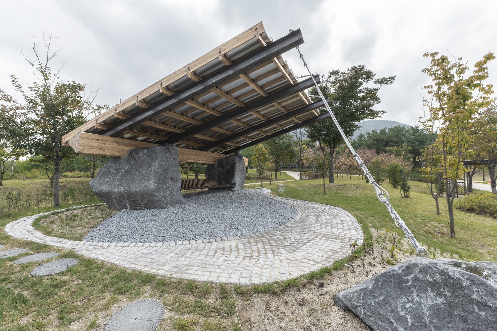 SO? Architecture Balances a Timber Canopy on Granite Boulders for a Biennale Pavilion in Korea