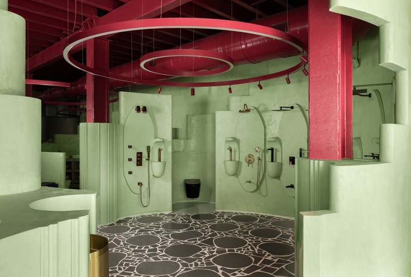 Shower area with three arched niches set into pale green walls below circular hanging light fixtures