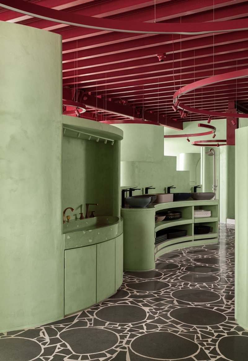 Bathroom vanity area with vessel sinks and open shelving beneath an exposed red slatted ceiling