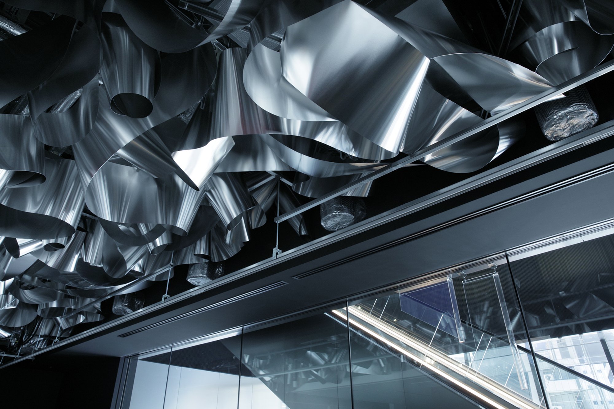 Moriyuki Ochiai and Harumaki Project Suspend a Crumpled Metal Waterscape over a Tokyo Office