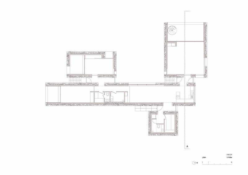 Floor plan drawing showing four pavilions connected by a linear corridor on sloping terrain