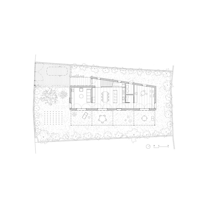 Ground floor plan drawing showing interior rooms and covered outdoor terrace with surrounding garden
