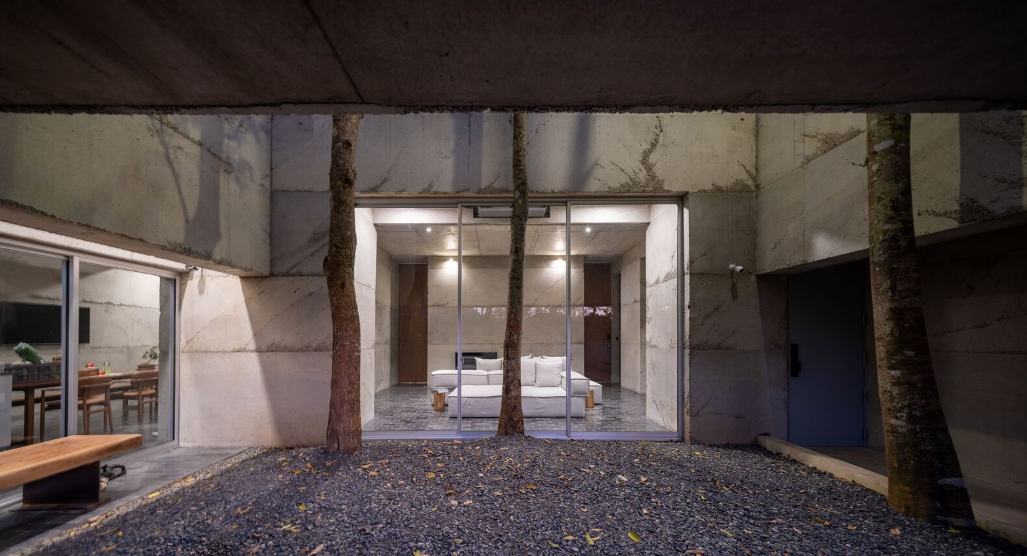 JOYS Architects Weaves a Concrete House Through the Trees in Rural Thailand