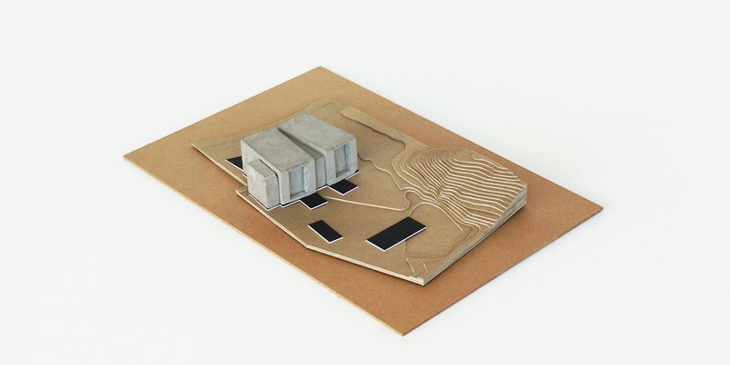 Physical model from opposite angle revealing concrete structures and contoured landscape surface