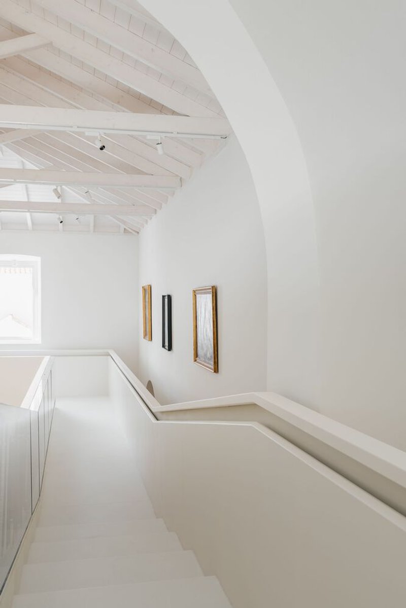 Corner of the mezzanine level showing the arched opening and light timber roof structure above