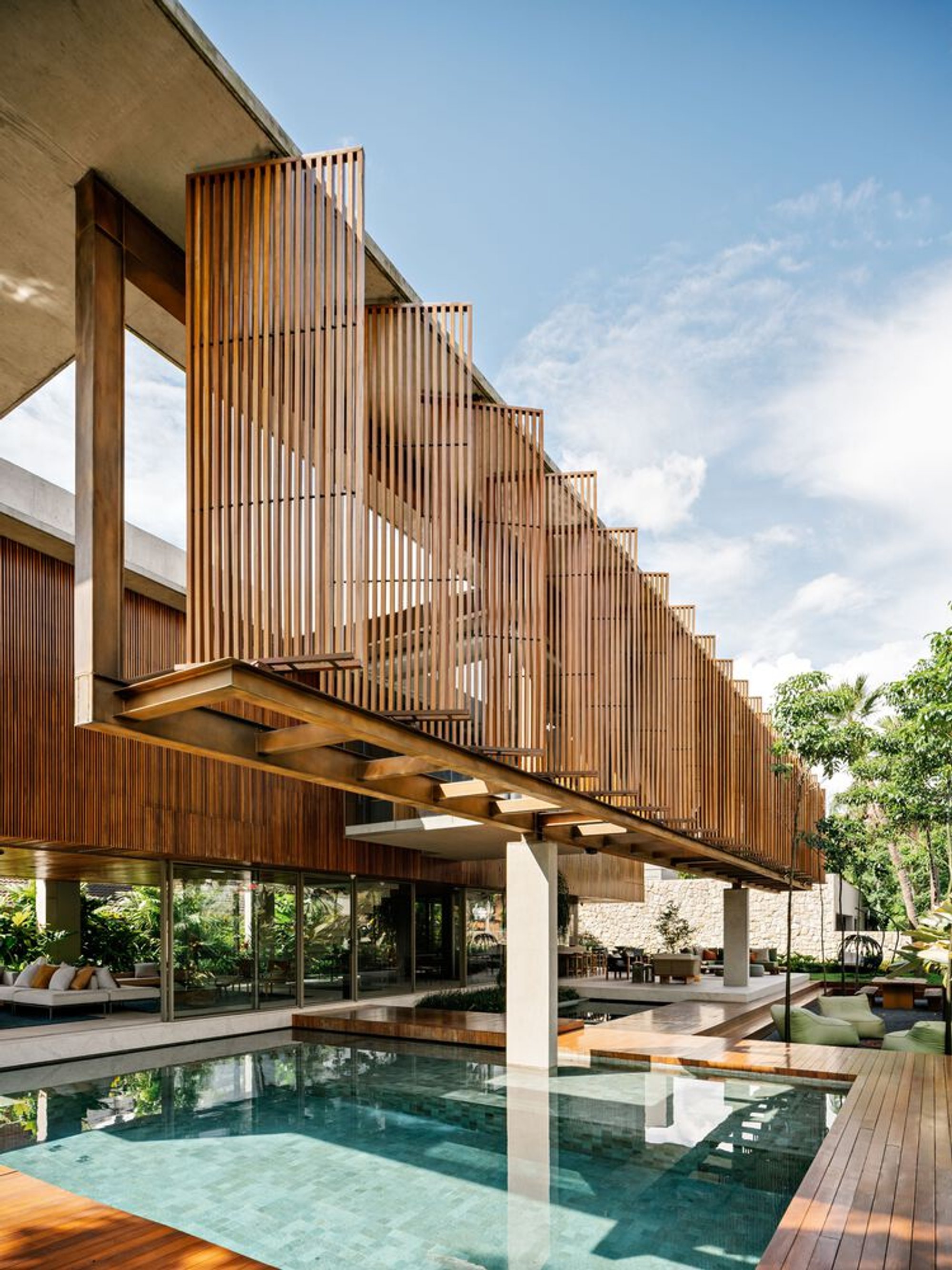FGMF Suspends a Cumaru Wood Volume Over a Glass Pavilion in São Paulo's Tropical Suburbs