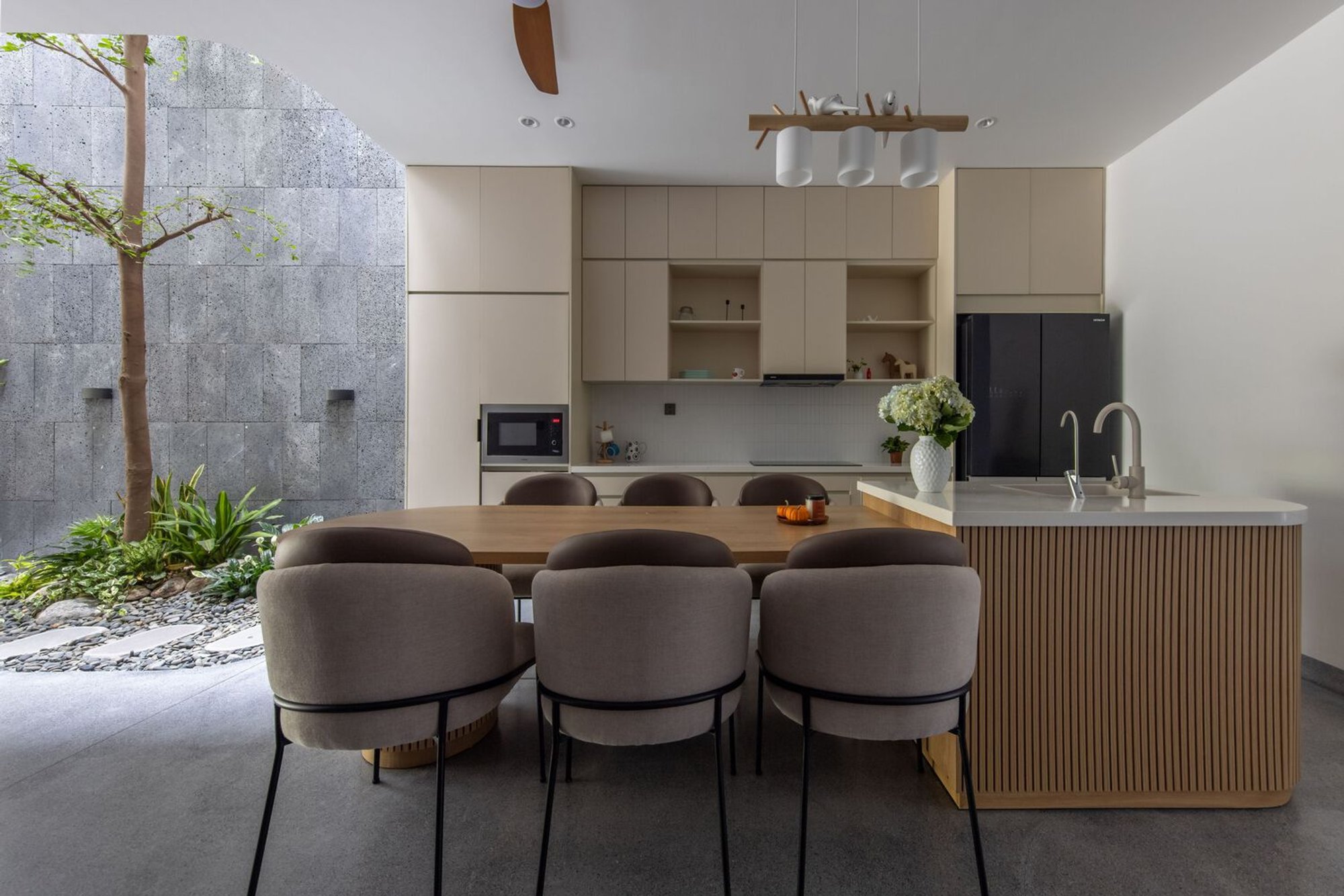 X11 Design Studio Carves Three Breathing Voids into a Vietnamese Tube House for a Multigenerational Family