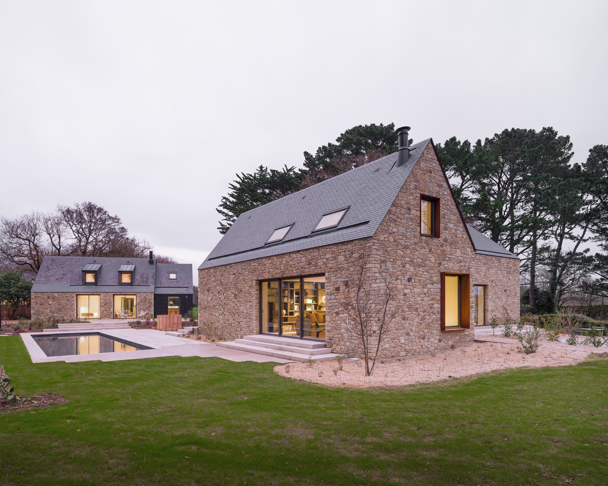 MSR Architecture Stitches a French Farmstead Back Together with Granite, Corten, and a Village Square Pool