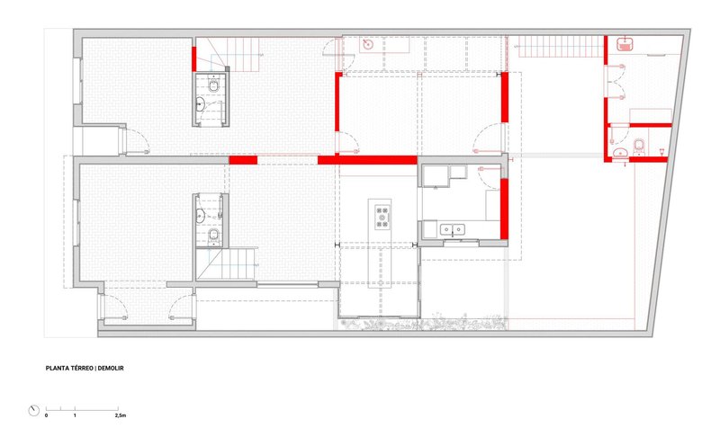 Floor plan drawing showing living areas with red highlighted structural elements and bathrooms