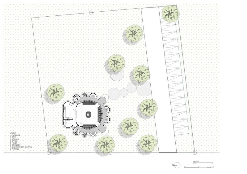 Site plan drawing showing the organic building form with surrounding trees and adjacent linear structure